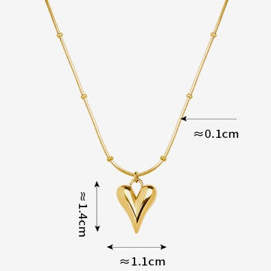 Shop now the Love Heart Pendant Necklace from Amore Jewellery! This stunning necklace features a heart-shaped pendant made of high-quality surgical titanium steel, 18K gold plated for a luxurious finish. The bright metal gleams, adding an easy-chic touch to your look. Available in gold and silver