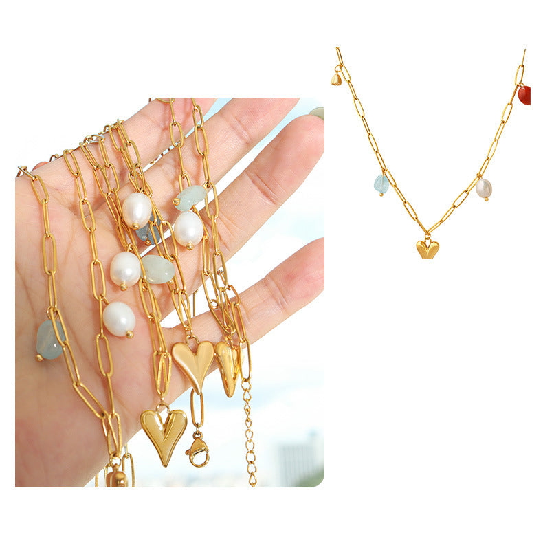 Shop now the exquisite Love Heart with Pearls and Stones Necklace from Amore Jewellery! This gold-plated necklace features a captivating golden heart pendant adorned with natural stones and a genuine natural freshwater pearl. Embrace elegance and romance with this enchanting design."