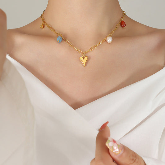 Shop now the exquisite Love Heart with Pearls and Stones Necklace from Amore Jewellery! This gold-plated necklace features a captivating golden heart pendant adorned with natural stones and a genuine natural freshwater pearl. Embrace elegance and romance with this enchanting design."